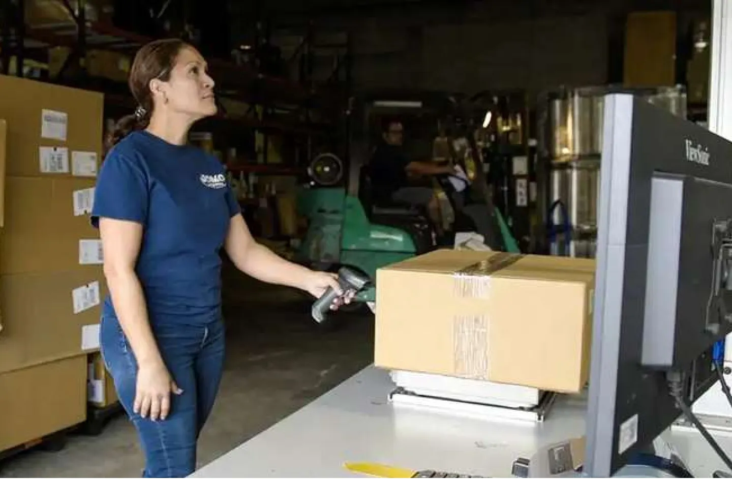 Warehouse Problems - A woman scanning a parcel