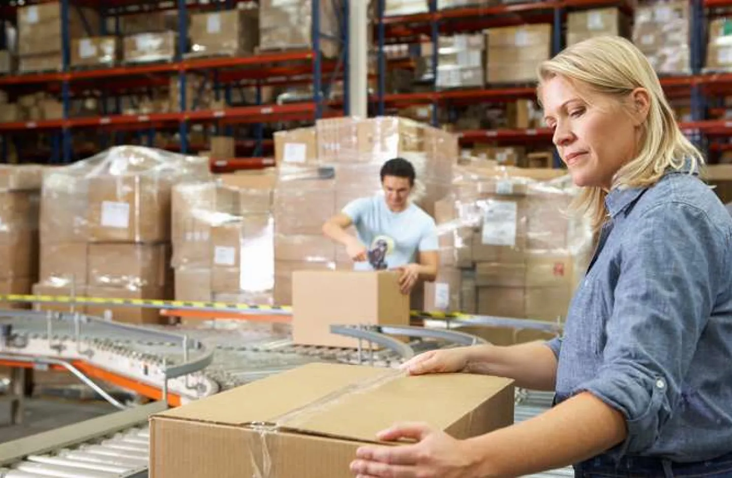 Warehouse workers working in a packing area.