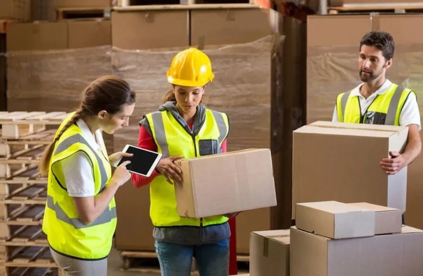 Warehouse workers minimizing business risk through reverse logistics.