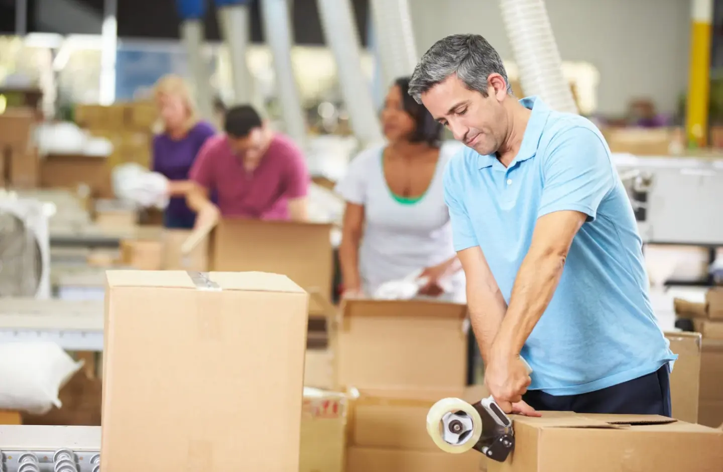 A warehouse clerk packing items for shipping.